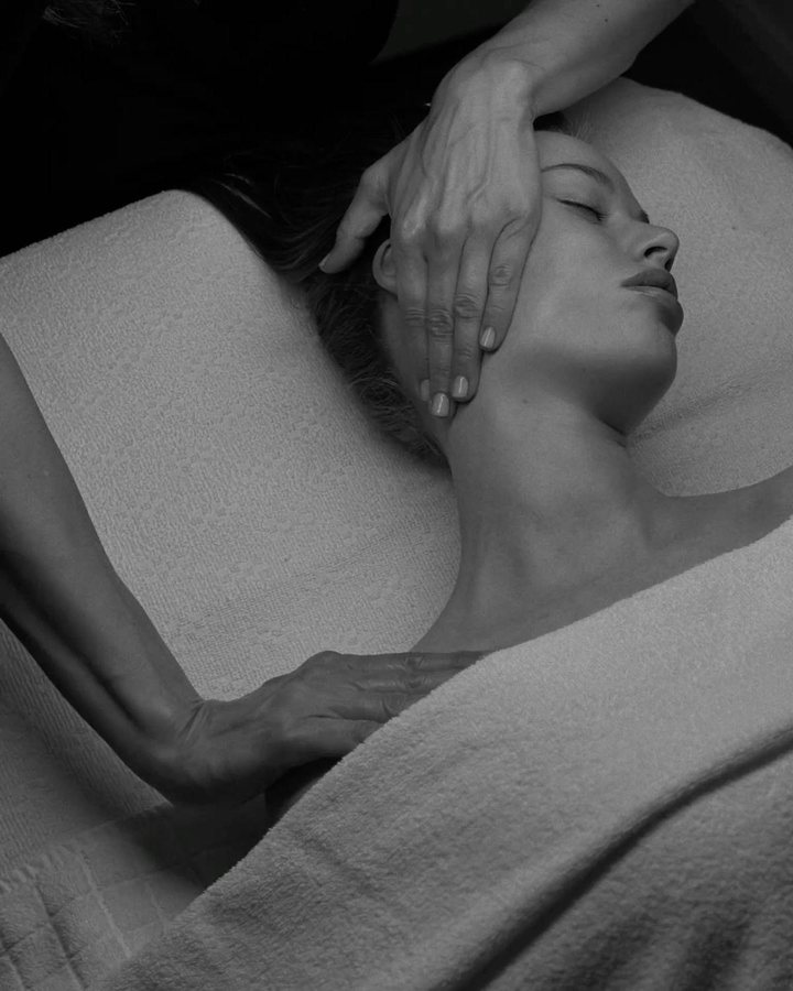 Black-and-white photograph of a neck and jaw massage